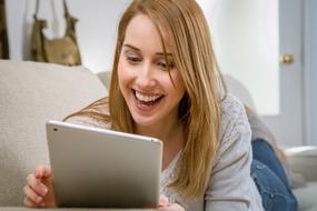 happy girl with white tablet