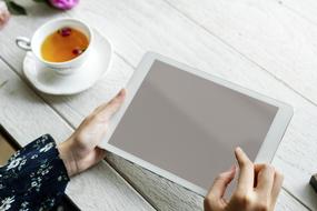 tablet in femane hands at table