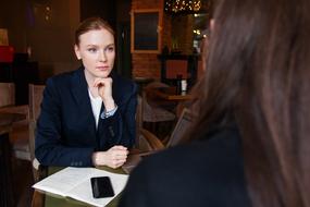 Business women in suits, on the meeting