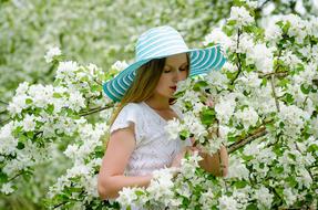 Girl Beauty in white flowers garden