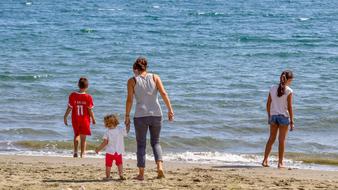mother with children on the beach