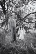 Black and white photo of the mother with the daughter on the flora background