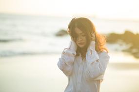 Woman on the seascape with the sunshine