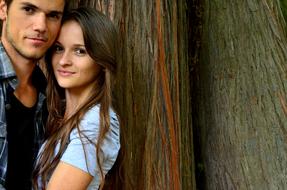 Young couple on the wood background