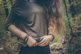 Fashionable young woman in the forest