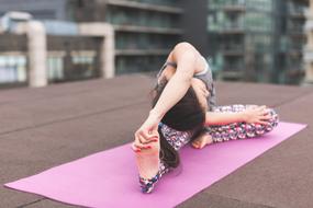Woman doing yoga exercises on the mat