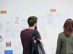 back view of young man and woman in front of presentation