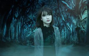 silhouette of a girl on the background of a mystical forest