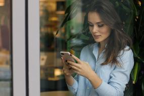 girl with a phone by the window
