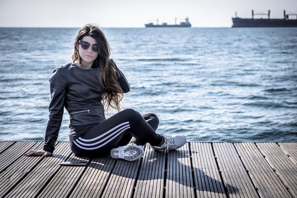 photo of a girl on a wooden floor by the sea