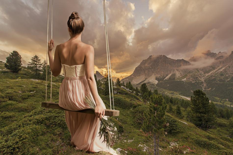 bride on a swing on a hill
