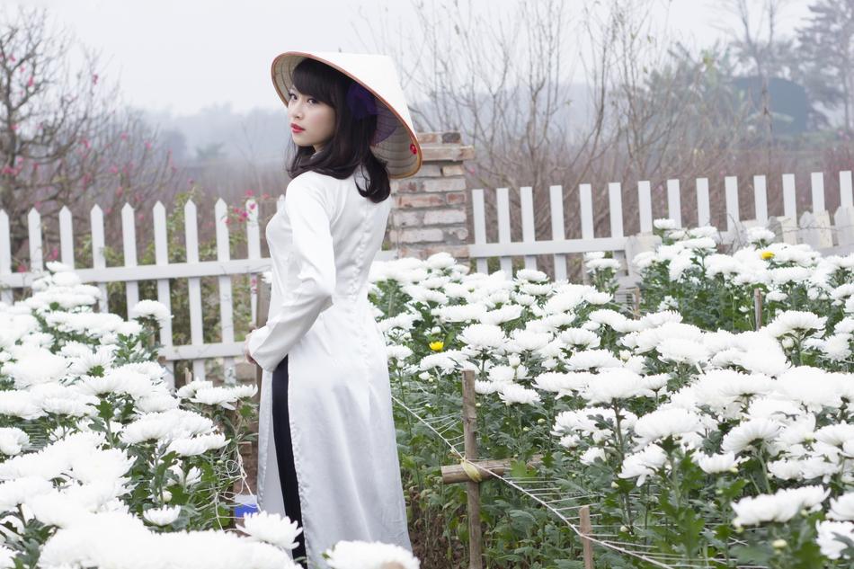 girl in the garden near white flowers