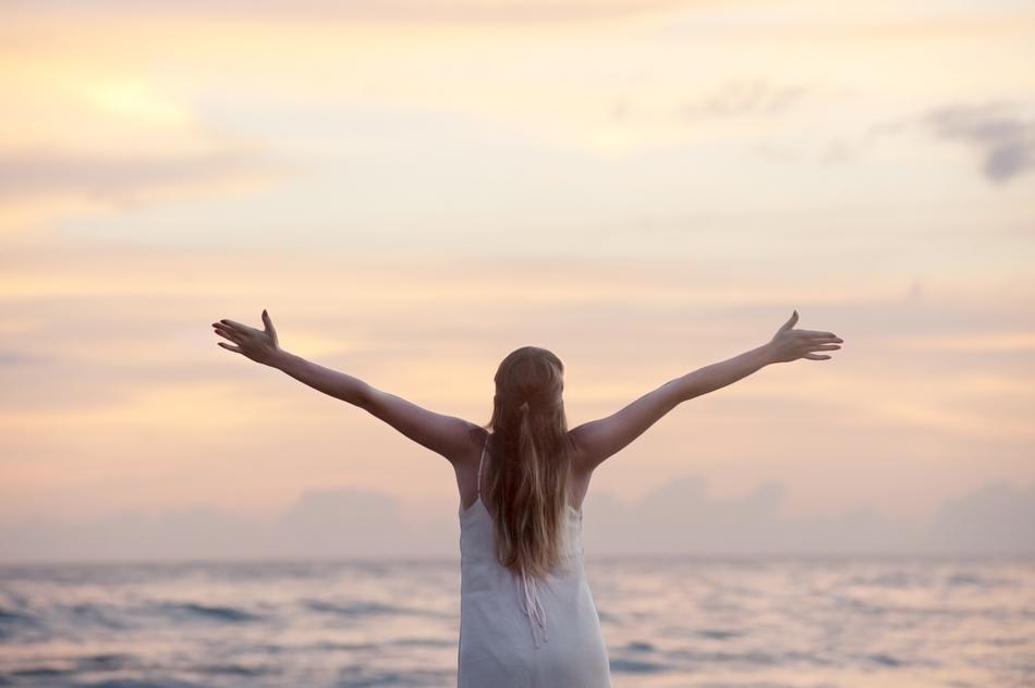 Woman standing near the water on the seascape