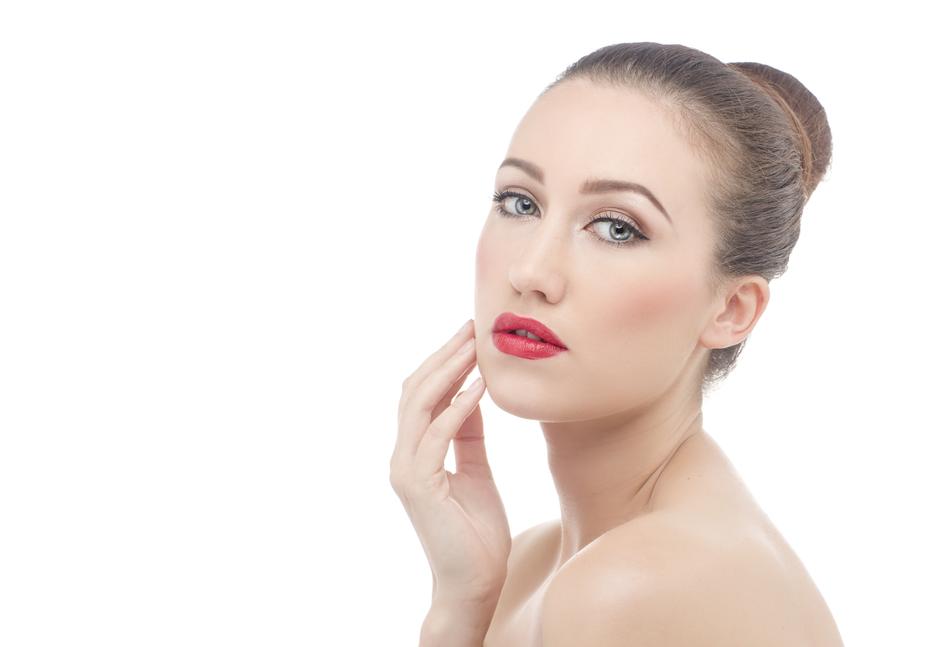 Portrait of the woman, with red lips, hairstyle and shiny skin, at white background