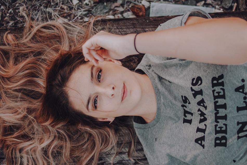 portrait of recumbent young woman with long hair