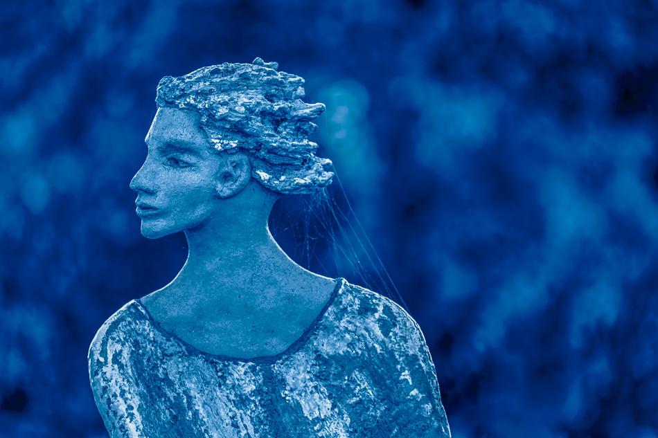 Beautiful, blue and white sculpture of the Snow Queen, at blurred background