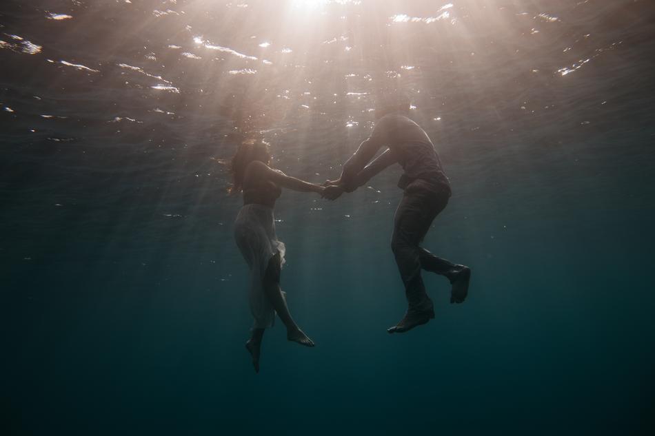 couple in water holding hands