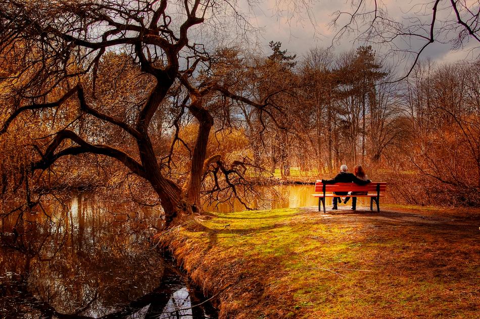 Lovers on the beautiful landscape near the river among colorful plants