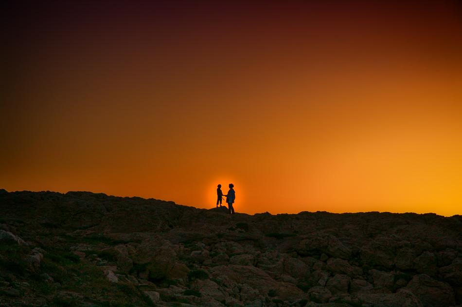ASilhouette of the couple on the landscape with the light clipart