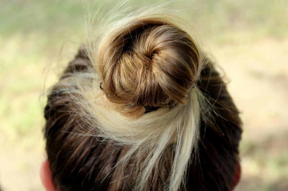 Close-up of the beautiful, blonde and dork hairstyle on the head of a woman, at blurred background