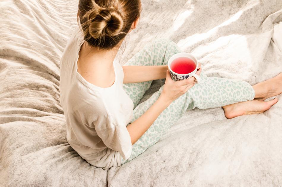 woman with a cup in bed