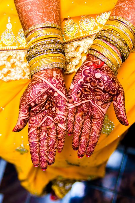 Colorful mehendi in the arms of the bride