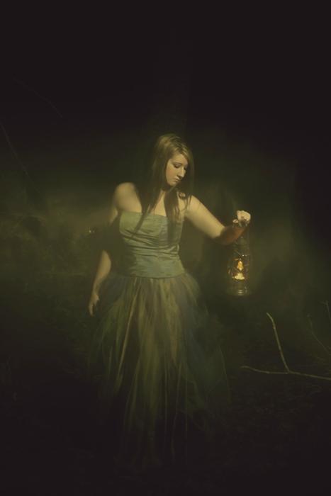 portrait of a girl with a lantern in the dark