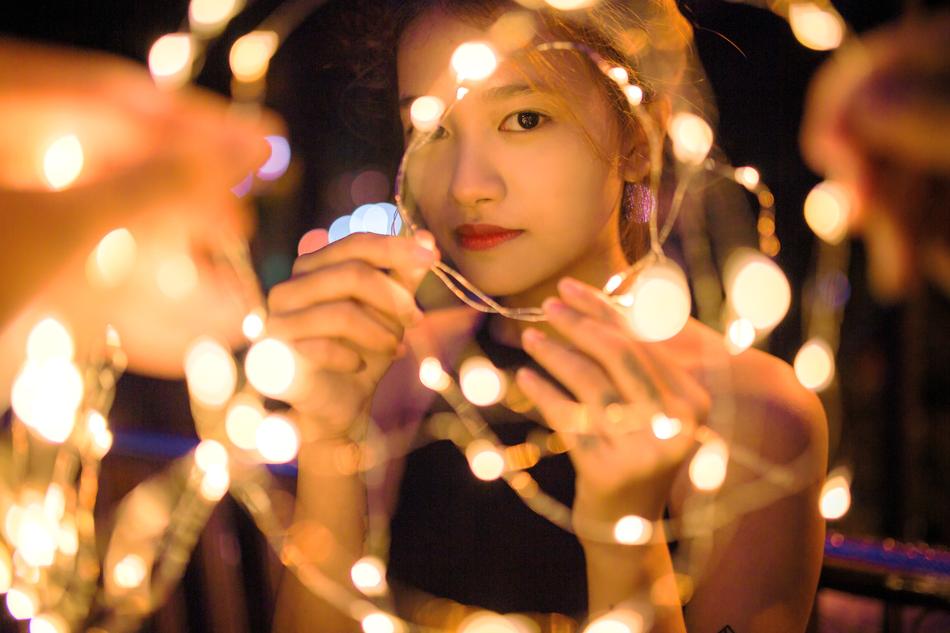a young girl behind a garland