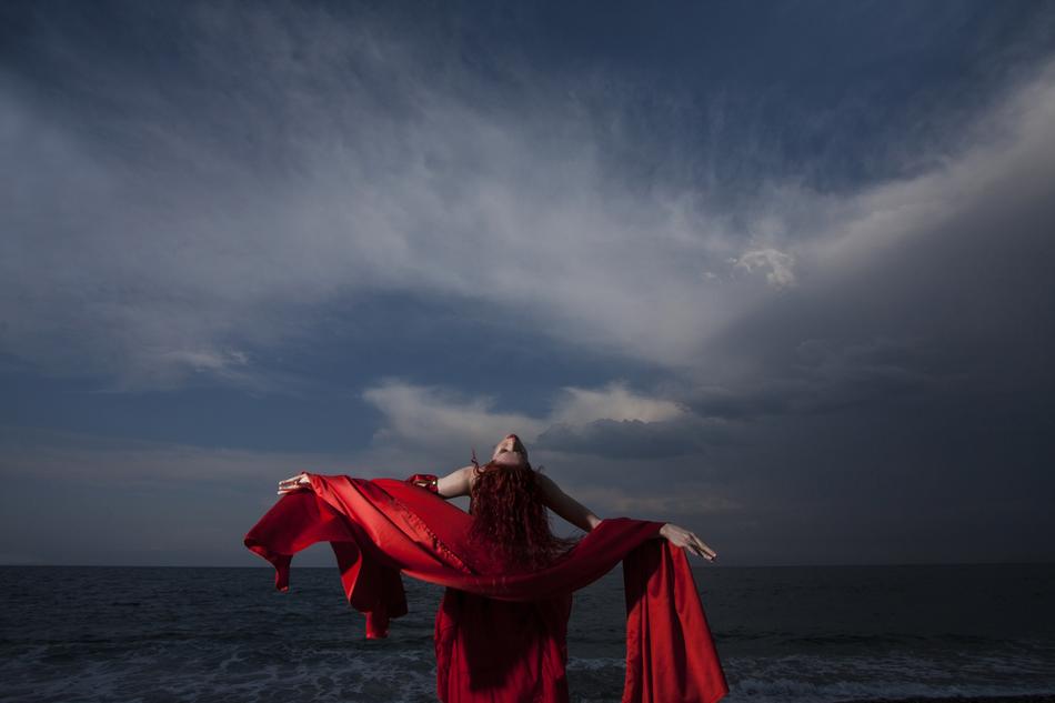 Woman in Red dress on shore
