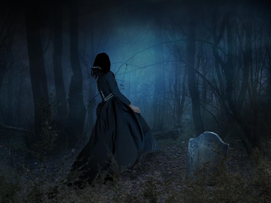 girl in a foggy forest near the grave