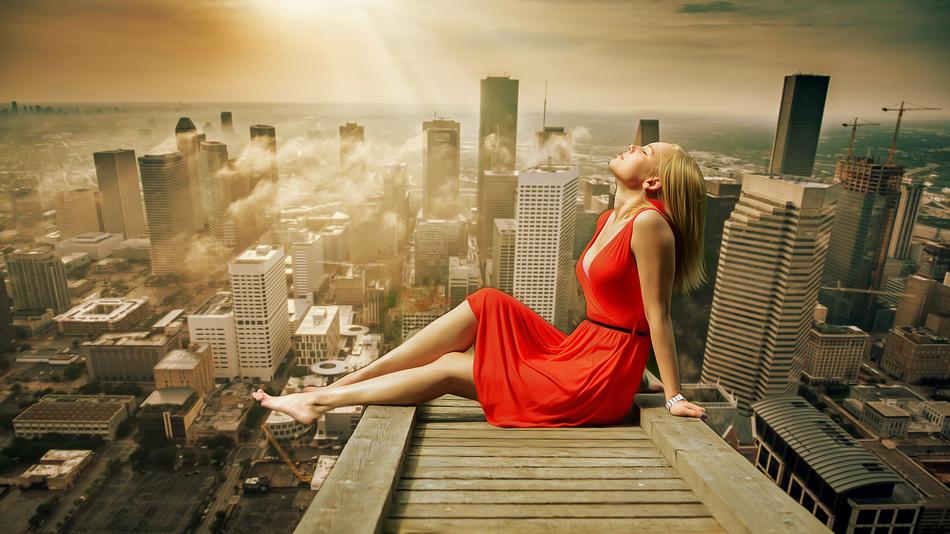 young Girl in red dress sits above the city in light, collage