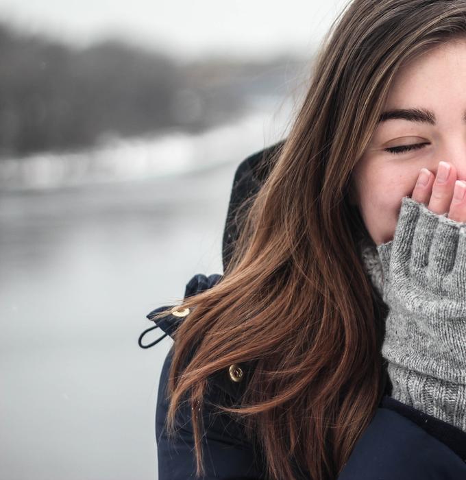 sneezing young woman