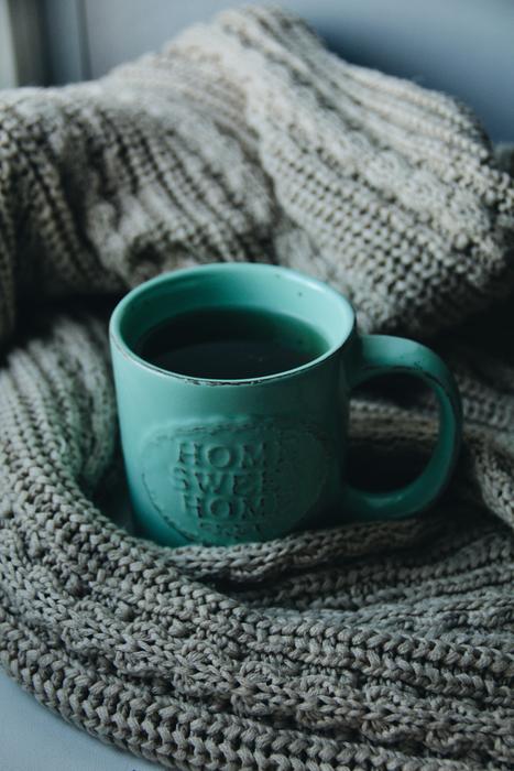 green cup with a drink on wool