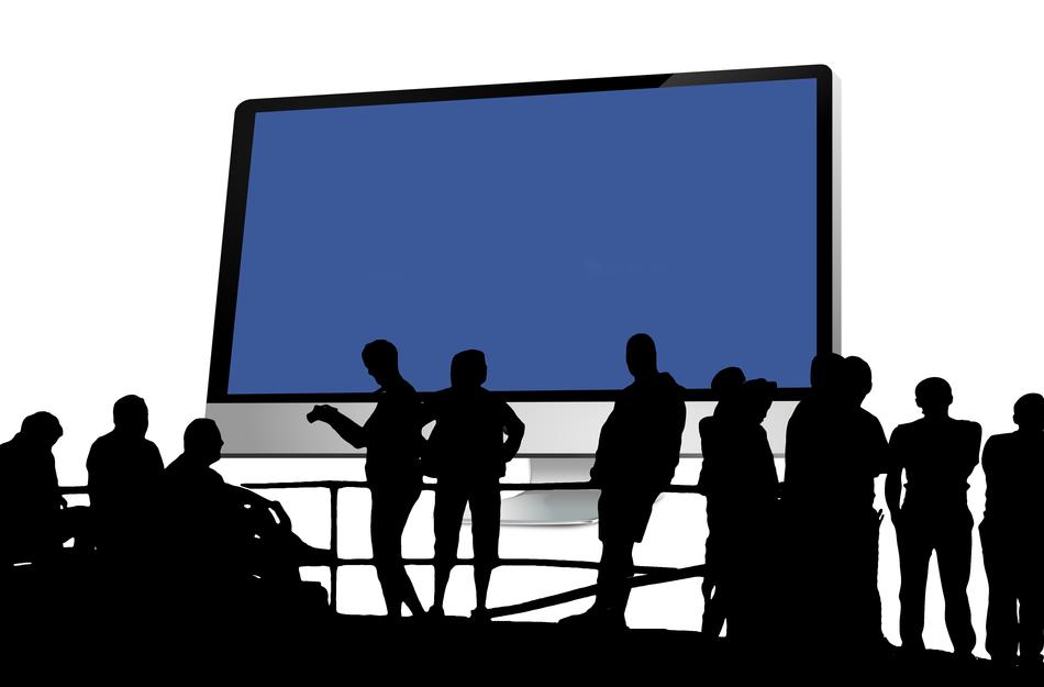 silhouettes of people on the background of the monitor