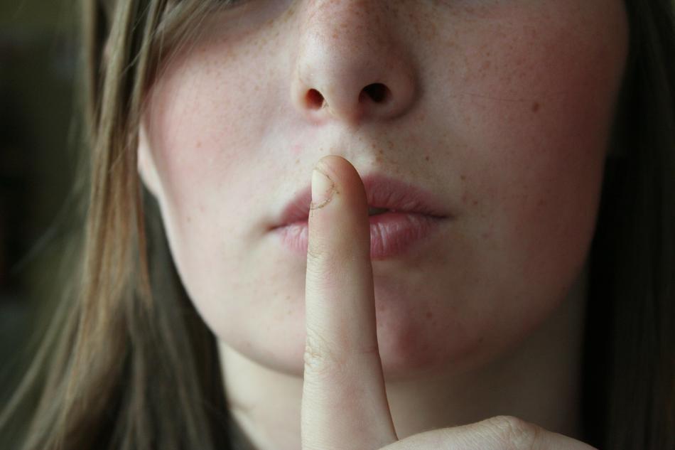 Secret, girl with finger at Lips