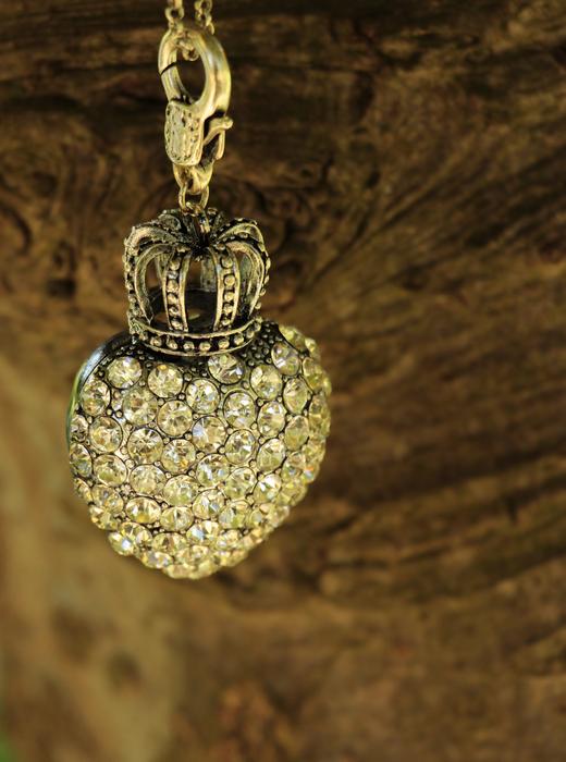 gemstone pendant with crown hanging on tree