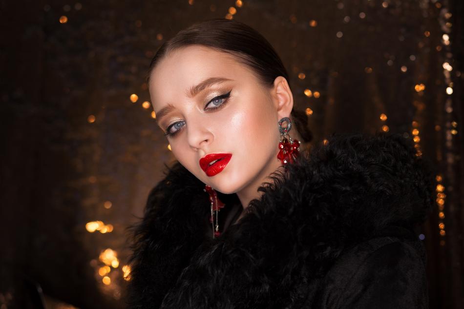 portrait of a girl with red lips on a bokeh background