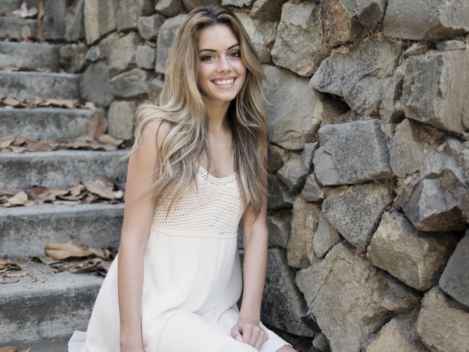 Smiling beautiful girl near the rocks