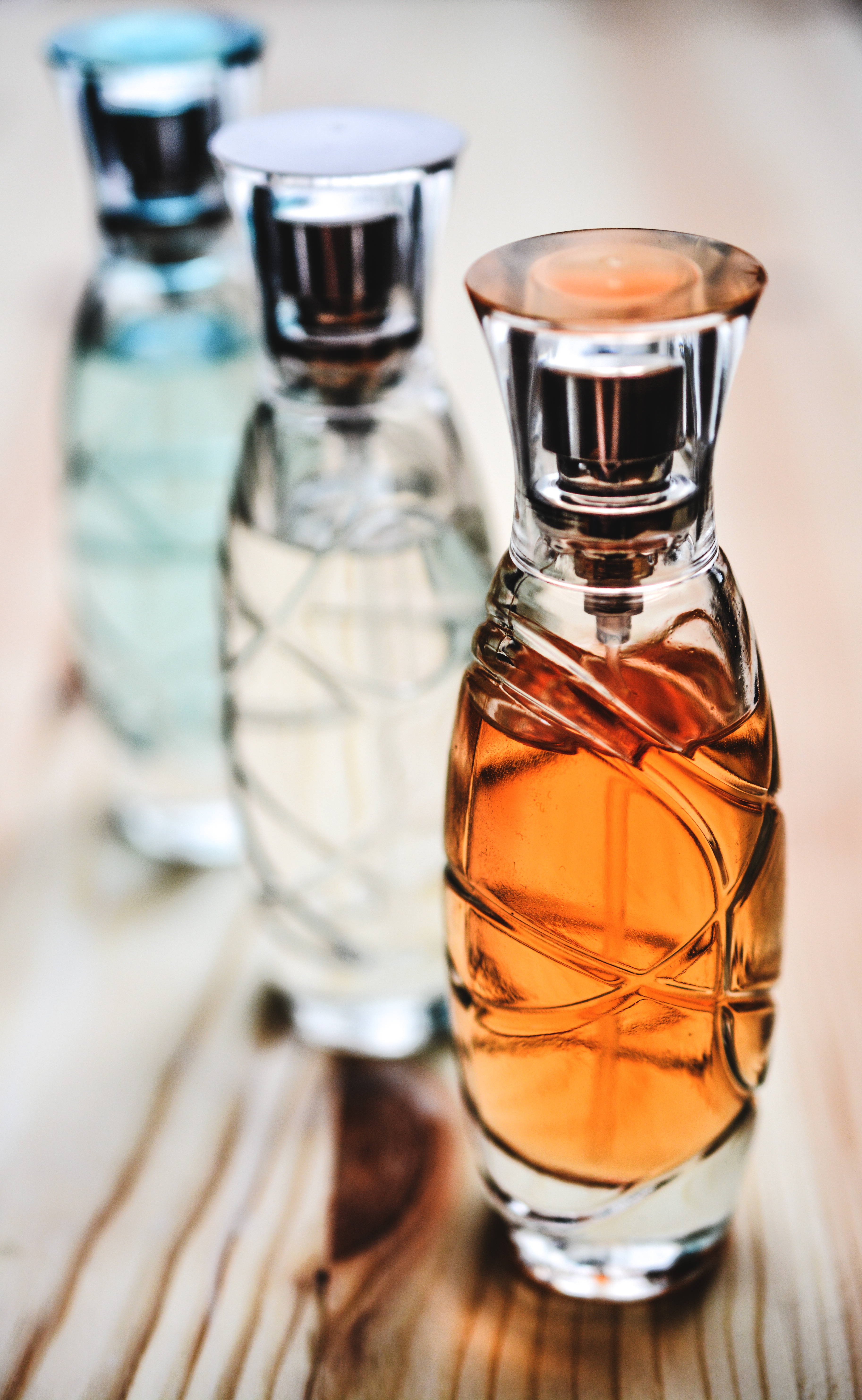 Bottles with perfume on the table on a blurred background free image  download