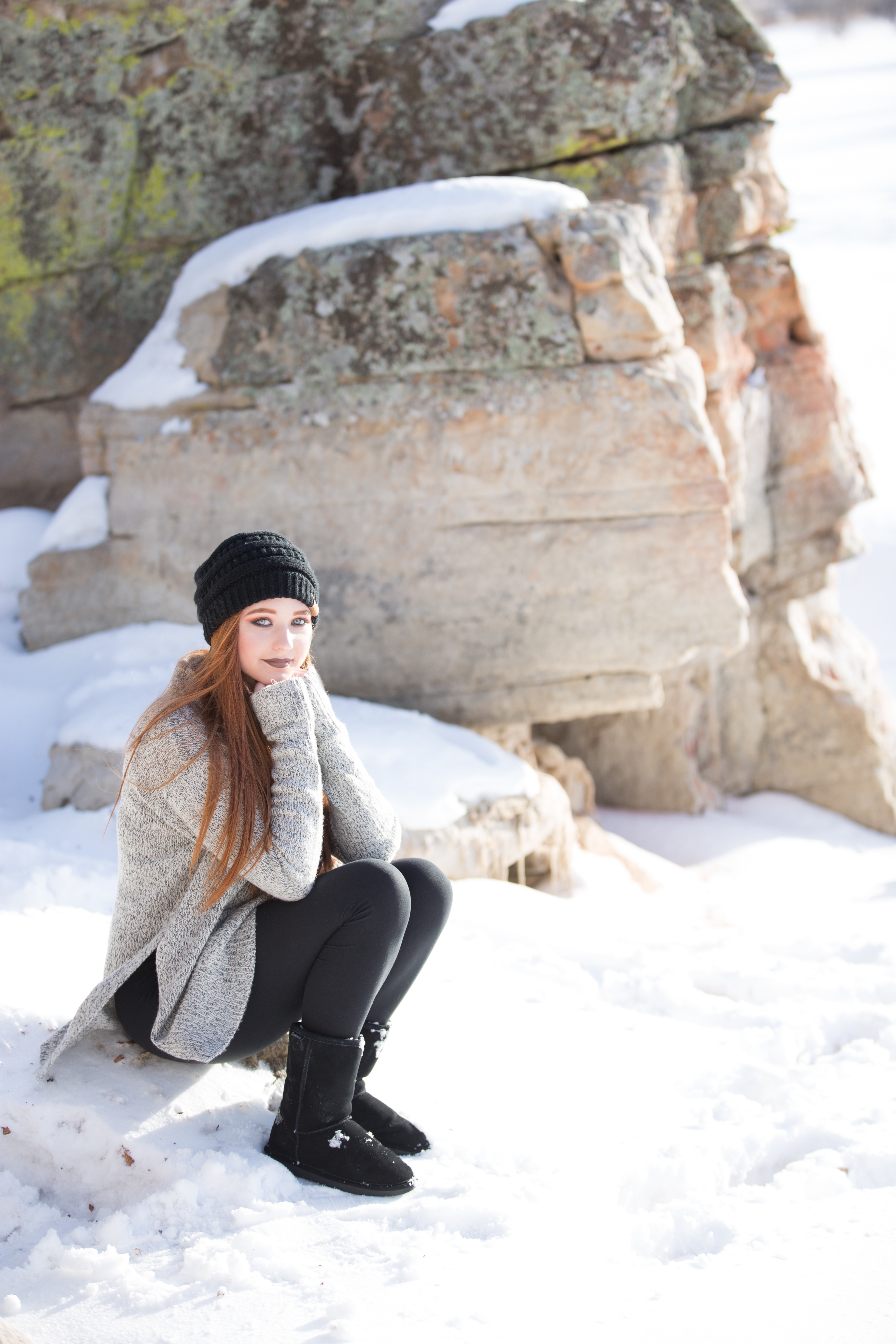 Girl Is Sitting On A Stone On The Background Of A Snowy Rock Free Image Download