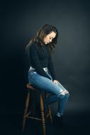 lonely girl is sitting in a high chair