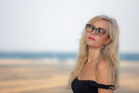 blonde in sunglasses on the beach