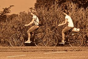 monochrome photo of a girl riding bicycles