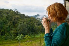 woman with a cup of coffee on nature background