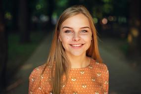 Portrait of a cute, blonde girl in orange t-shirt