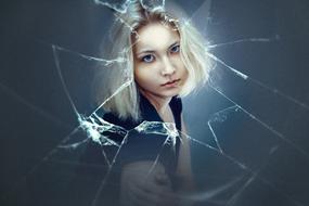 blonde Girl looks through broken glass