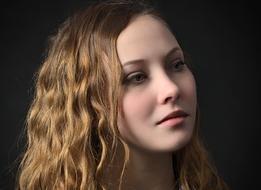 Portrait of the blonde, smiling woman, with the curly hair and make-up