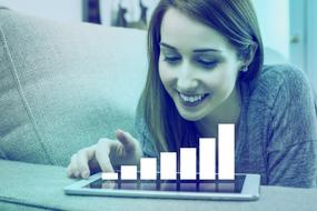 Businesswoman looking at growth diagram on screen of tablet
