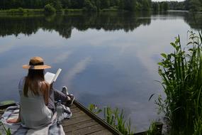 girl on the pier with a book