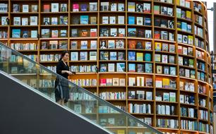 young woman on escalator at Book shelves, south korea, seoul